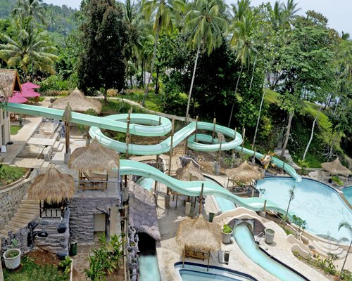 An outdoor swimming pool with water slides.