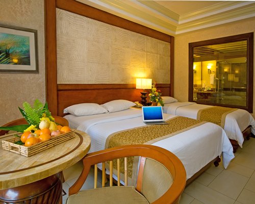 A well furnished bedroom with two beds.