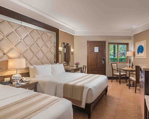 A well furnished bedroom with two beds.