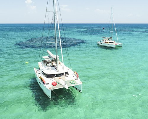 A view of a sailboat in the ocean.