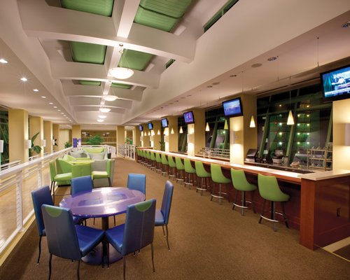 An indoor bar with bar counter and restaurant at Wyndham Vacation Resorts Panama City Beach.