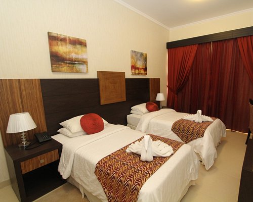 A well furnished bedroom with two beds.
