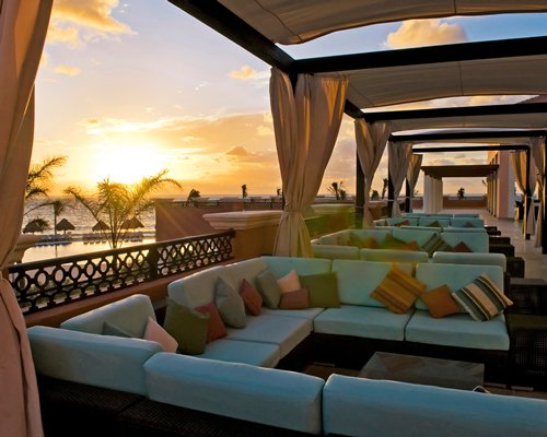 A well furnished outdoor lounge area at dusk.