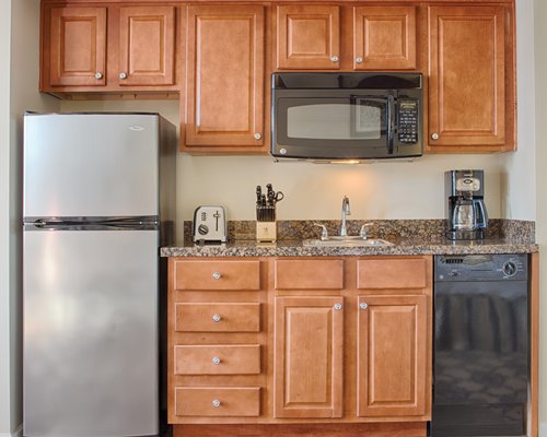A well equipped kitchen with a microwave oven and refrigerator.