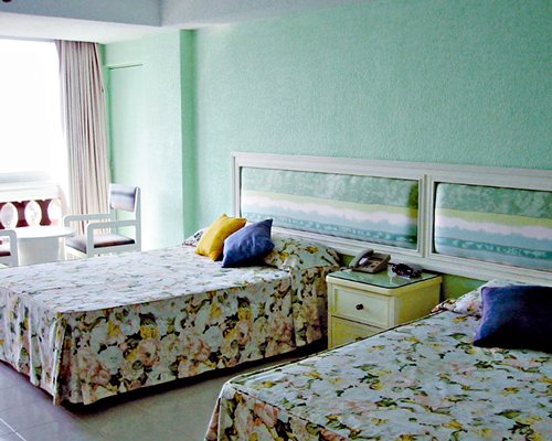 A well furnished bedroom with two beds.