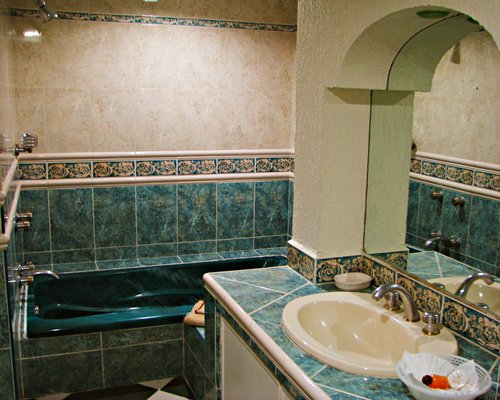 A bathroom with single sink vanity and a bathtub.