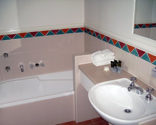A bathroom with shower and bathtub.