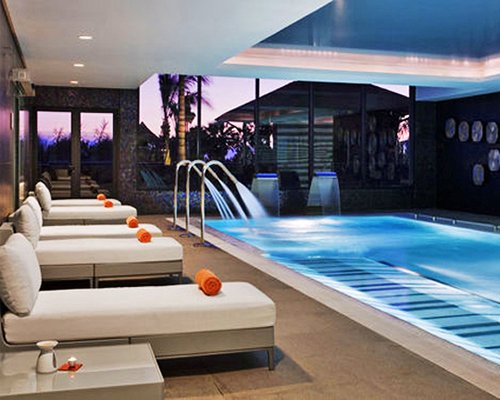 An indoor lounge area alongside the swimming pool.