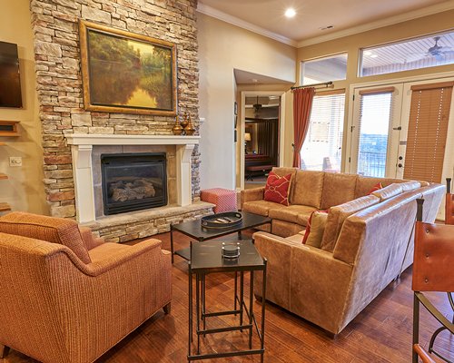 A well furnished living room with a pull out sofa and fireplace.