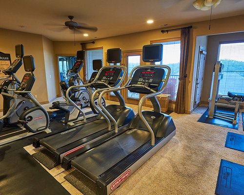 An indoor recreational room with pool table and patio furniture.