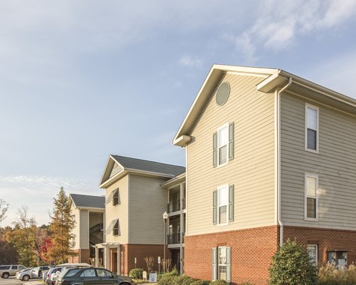 An exterior view of multi story resort units with a parking lot.