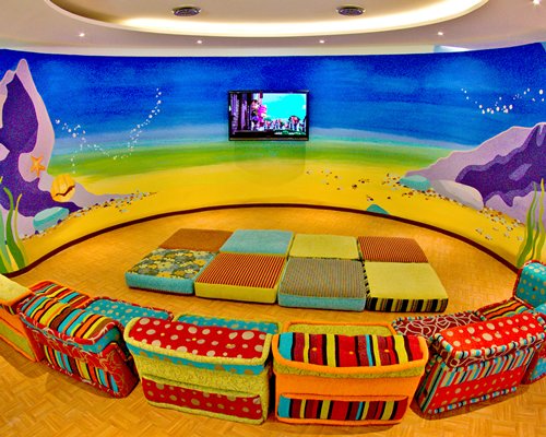 Indoor kids recreation room with television.