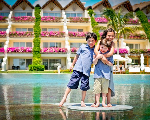 View of kids on the waterfront alongside the resort.