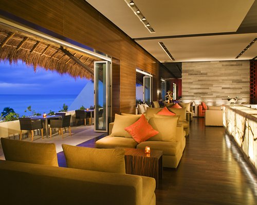 An indoor lounge area with a sea view.