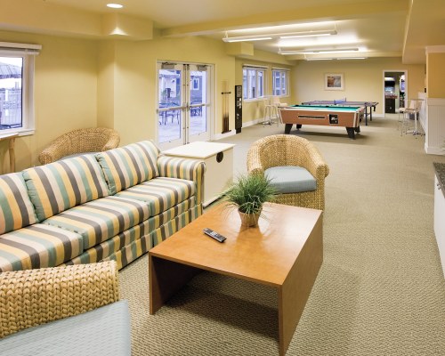 INDOOR RECREATION ROOM WITH POOL TABLE PING PONG AND LOUNGE AREA.