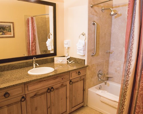 A bathroom with shower bathtub and closed sink vanity.