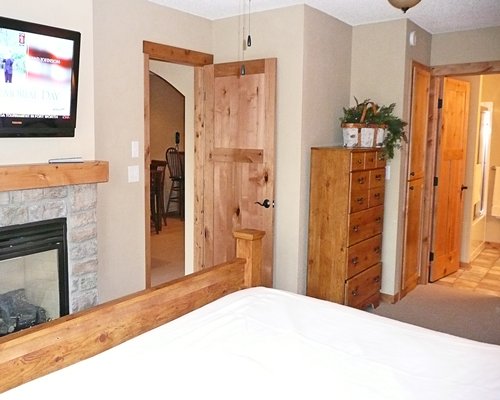 A well furnished bedroom with fireplace.