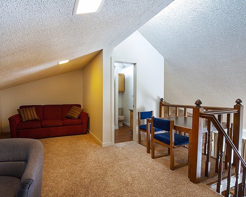 Interior view of a living room with dining area bathroom and a stairway.