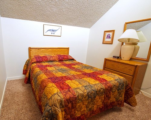 A well furnished bedroom with a queen size bed.