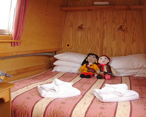 Interior view of the canal boat with a well furnished bedroom.