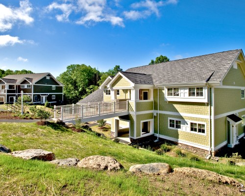 AN EXTERIOR VIEW OF MULTI STORY RESORT UNITS SURROUNDED BY TREES.