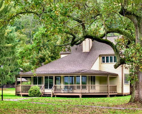 EXTERIOR VIEW OF A UNIT WITH STAIRWAY AND WOODEN PATIO .