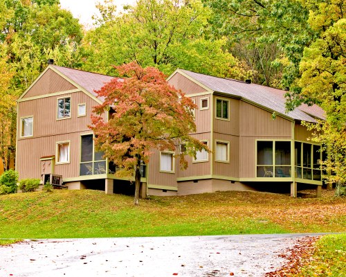 AN EXTERIOR VIEW OF MULTI STORY RESORT UNITS WITH TREES.