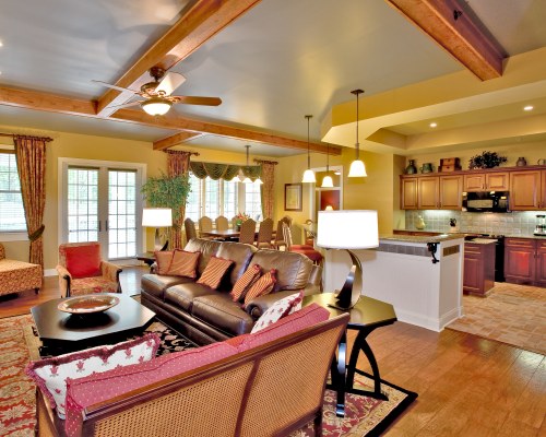 AN OPEN PLAN LIVING DINING AND KITCHEN AREA WITH DOUBLE PULL OUT SOFA.