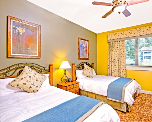 A WELL FURNISHED BEDROOM WITH TWO KING BEDS AND AN OUTSIDE VIEW.