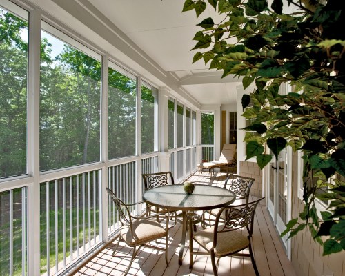 INDOOR DINING WITH CHAISE LOUNGE CHAIR AND SCENIC LANDSCAPE.