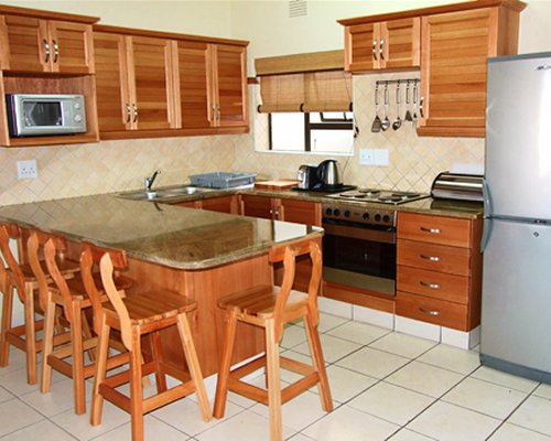 A well equipped kitchen and breakfast bar.