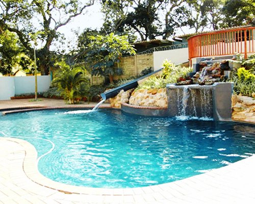 An outdoor swimming pool with water features.