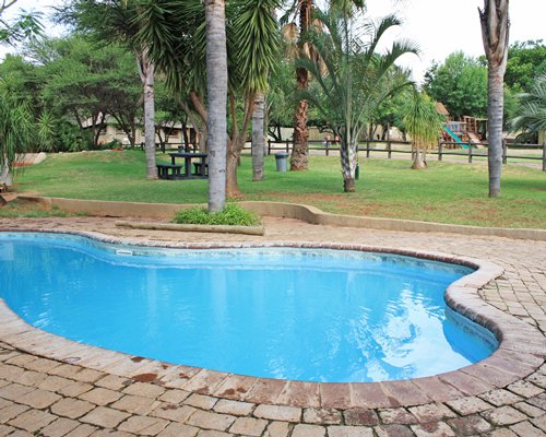 Outdoor swimming pool with landscaped picnic area.