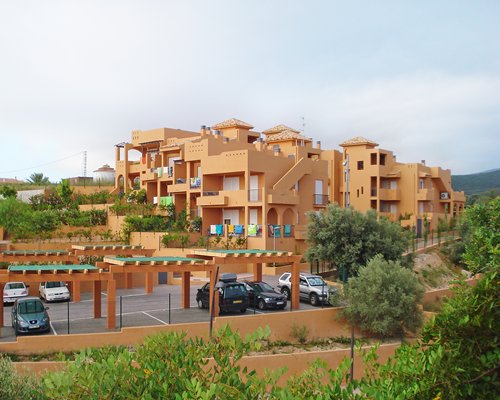 An exterior view of multi story units with the parking lot.