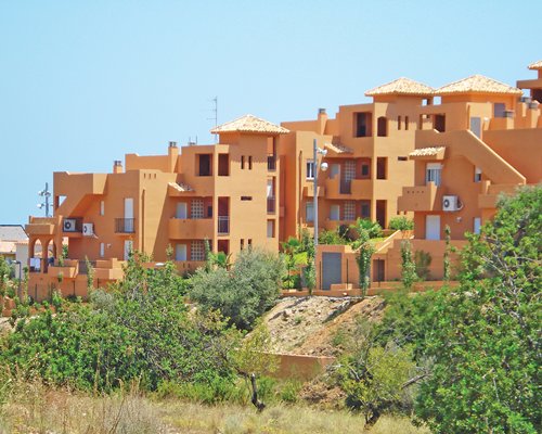 Exterior view of the Montemar Natura Resort surrounded by wooded area.