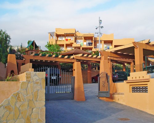 Scenic exterior view and pathway to Montemar Natura Resort with a parking lot.