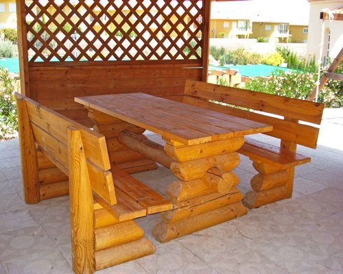 Picnic area alongside an outdoor swimming pool.