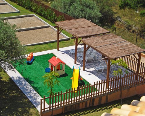 An aerial view of outdoor playscape with chaise lounge chairs.