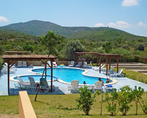 An outdoor swimming pool with chaise lounge chairs.