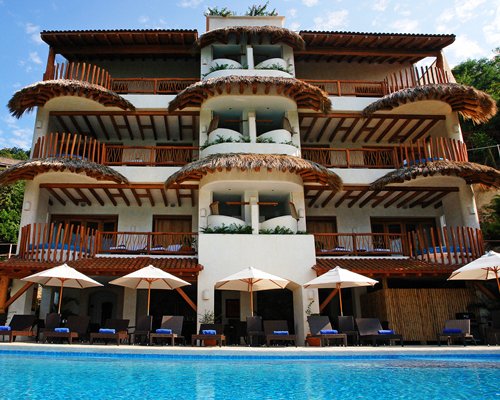 An outdoor swimming pool with chaise lounge chairs.