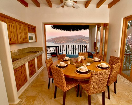 An open plan kitchen with dining area and ocean view.