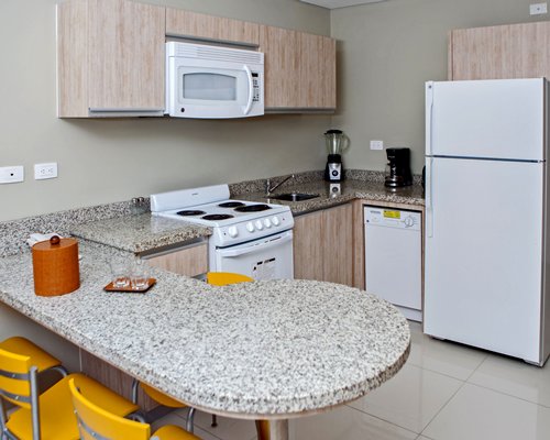 A well equipped kitchen with a microwave oven.