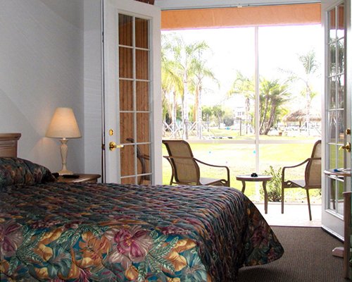 A well furnished bedroom with a patio.