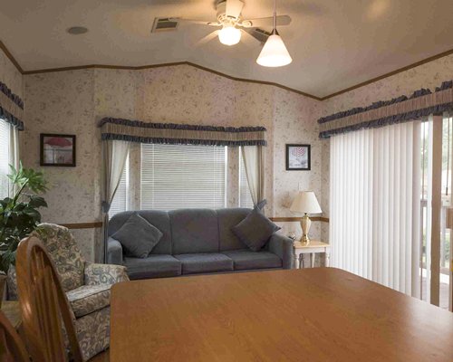 A well furnished living room with dining area and an outside view.