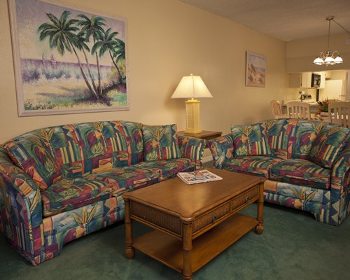 A well furnished living room with a dining area.