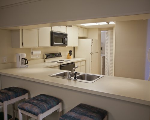 A well equipped kitchen and breakfast bar.
