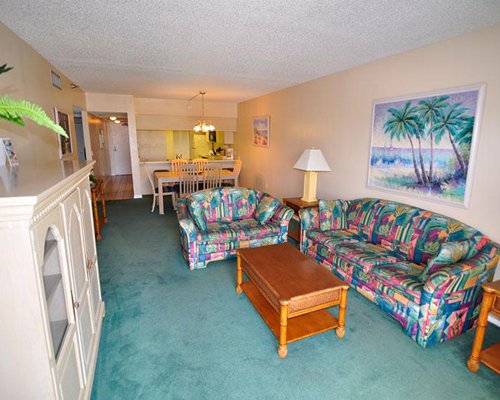 A well furnished living room with a dining area.