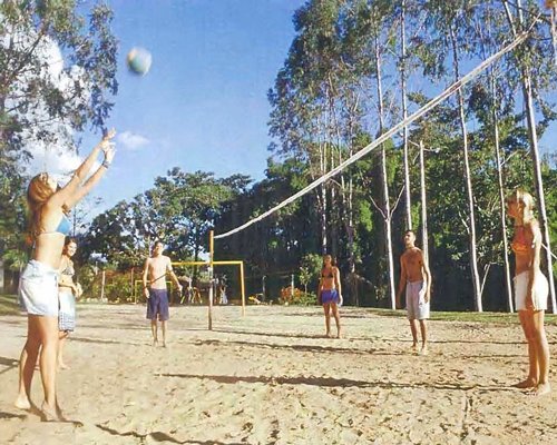 A group of people playing beach volleyball.