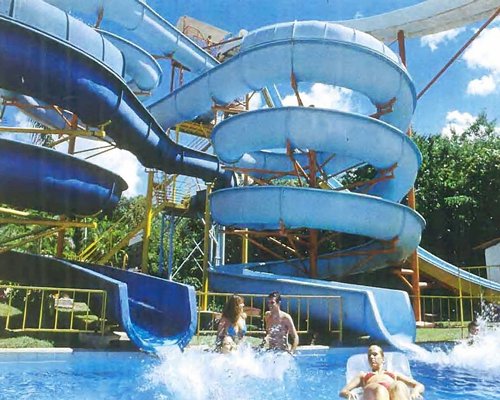 An outdoor swimming pool with water slides.