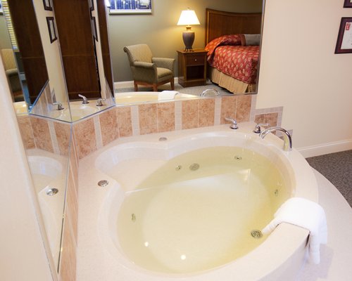 A well furnished bedroom with a bathtub.